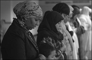 "Women pray during Friday noonday prayer ...