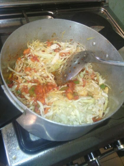 stirring shredded cabbage in the pot