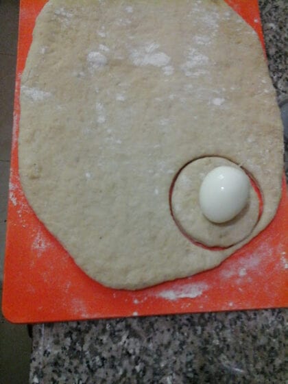 rolling egg roll dough flat and cutting before add the boiled egg