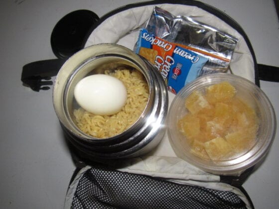 Nigerian school lunchbox meal of noodles with boiled egg